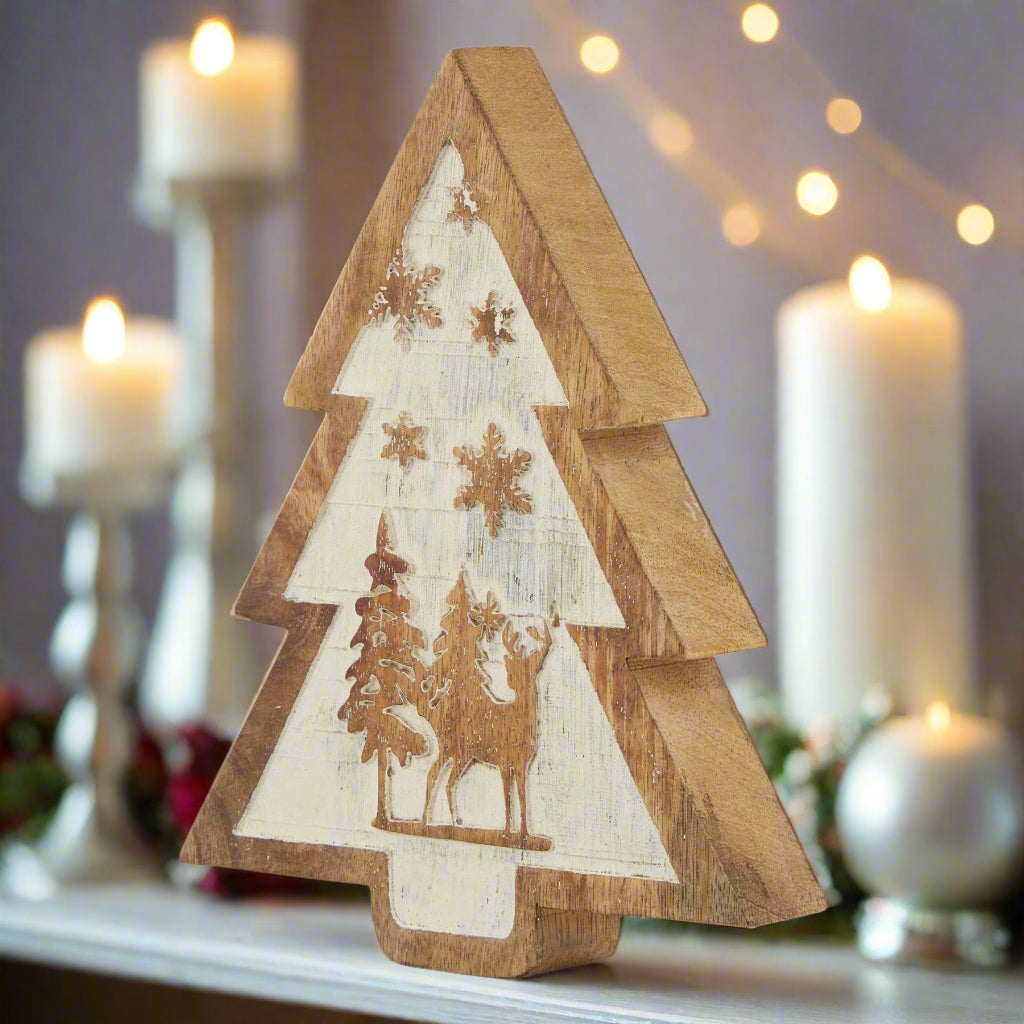 A rustic natural wooden snow scene tree decoration featuring a layered design with carved reindeer and snowy trees, perfect for a winter forest display.