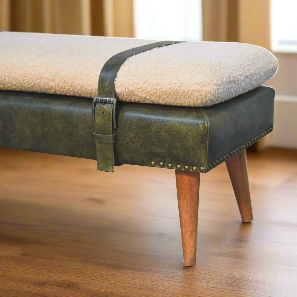 Angled side view of the left edge of the Olive Green Leather Boucle Bench's seat, showing the strapped-on seat and two legs.