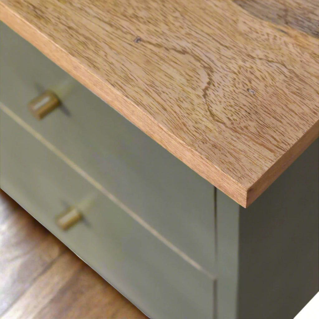 A closer look at the left edge of the olive hand-painted bedside table, focusing on the shiny drawer knob and the upper wooden surface.