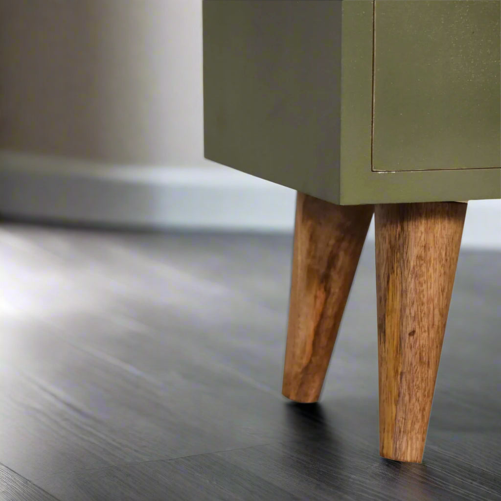 A closer view of the right side legs of the olive hand-painted bedside table, showcasing their oak-ish finish.