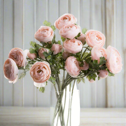 Bouquet of artificial pastel pink ranunculus in a clear glass vase – soft and elegant faux florals perfect for romantic home decor.