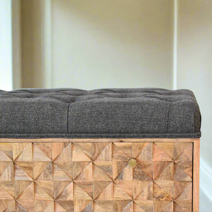 Close-up of hand-carved pineapple design on solid wood storage bench.