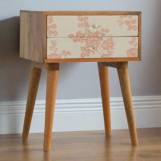 Front view of bedside table with oak-ish finish and two pink floral screen-printed drawers on Nordic-style legs – Purple Flamingo UK