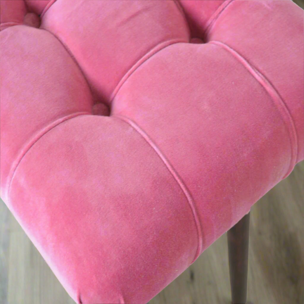 Aerial shot of the Pink Velvet Curve Stool's upholstery, clearly displaying the elegant deep button pattern on the seat.
