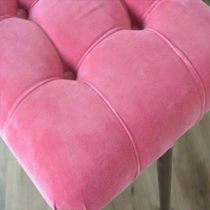 Aerial shot of the Pink Velvet Curve Stool's upholstery, clearly displaying the elegant deep button pattern on the seat.