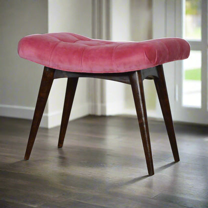 Angled front view of the Pink Velvet Curve Stool, showcasing its entire form with all four Nordic style legs and pink velvet upholstery.