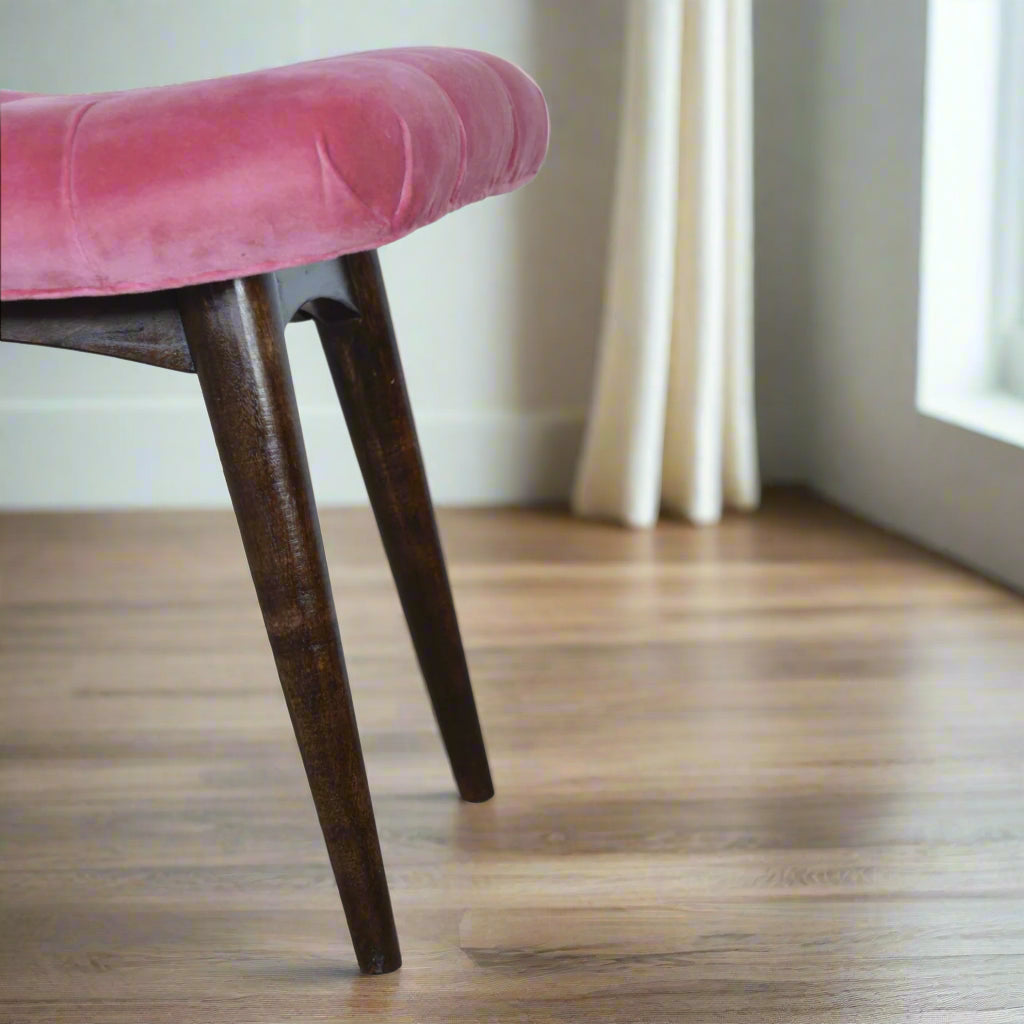 View focusing on the left edge of the Pink Velvet Curve Stool's seat and its corresponding left Nordic style legs.