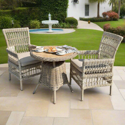Front view of a pair of the Provence Dining Chairs set up with a matching table.