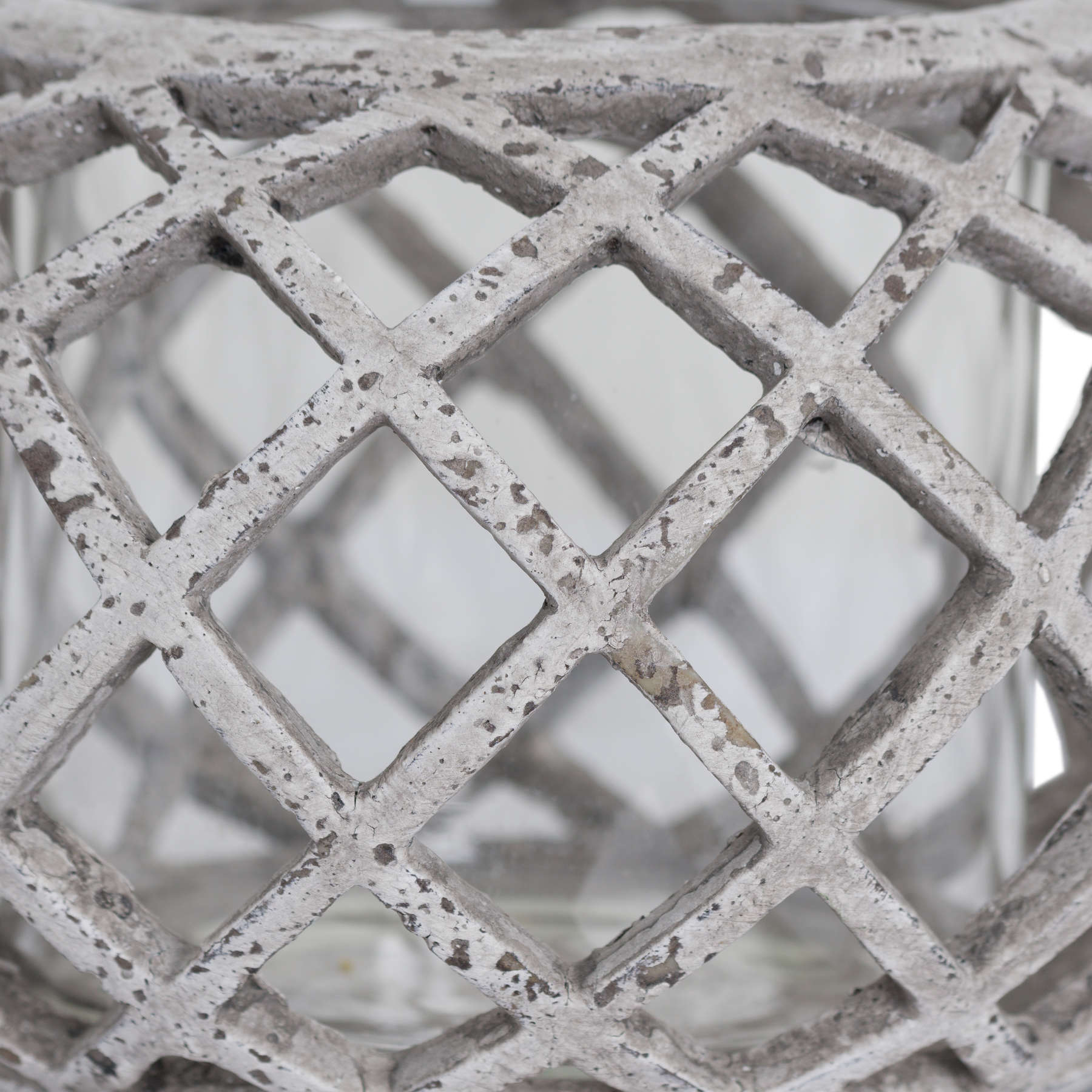 Zoomed-in view of the lattice pattern and soft stone finish of the round lantern.