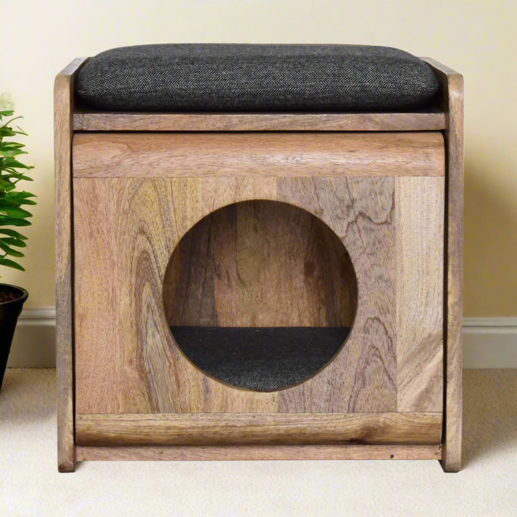 Front view of the round cut-out pet bed crafted from solid mango wood with an oak-ish finish, featuring a black tweed seat pad for stylish pet comfort.