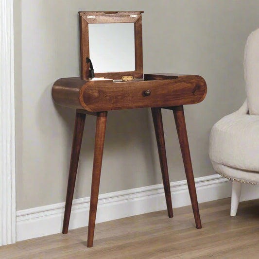 Rounded mini dressing table with honey caramel finish, showcasing front angled view with open fold-up mirror