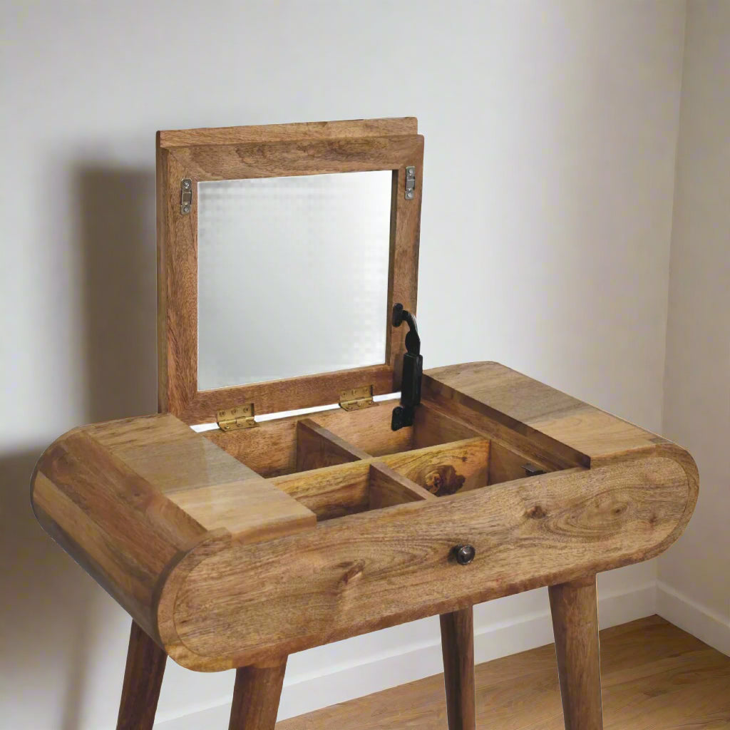 Close angle view of the rounded mini dressing table, with oak-ish finish, showcasing the fold-up mirror open, revealing storage compartments.