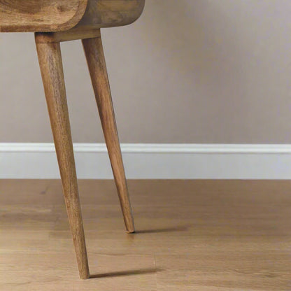 rounded mini dressing table, with oak-ish finish displaying close up of right nordic style legs