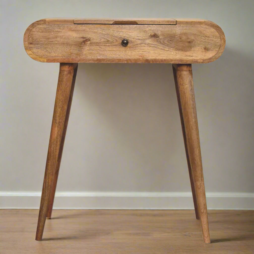 Front view of the rounded mini dressing table, with oak-ish finish, displaying nordic style legs.