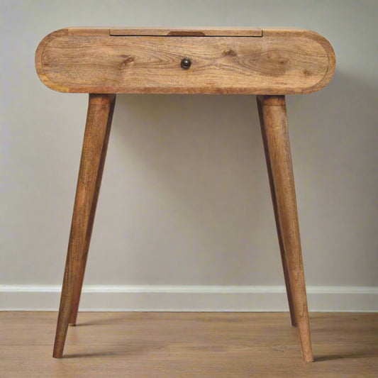Front view of the rounded mini dressing table, with oak-ish finish, displaying nordic style legs.