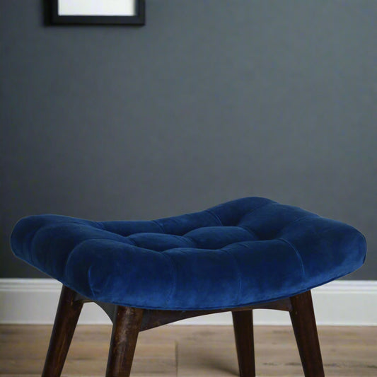 Elevated view of the Royal Blue Velvet Curve Stool, showcasing its plush blue seat and the upper part of its walnut finished legs.