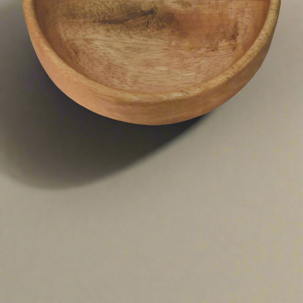 Focus on wood texture of one mango bowl – smooth surface and rich grain.