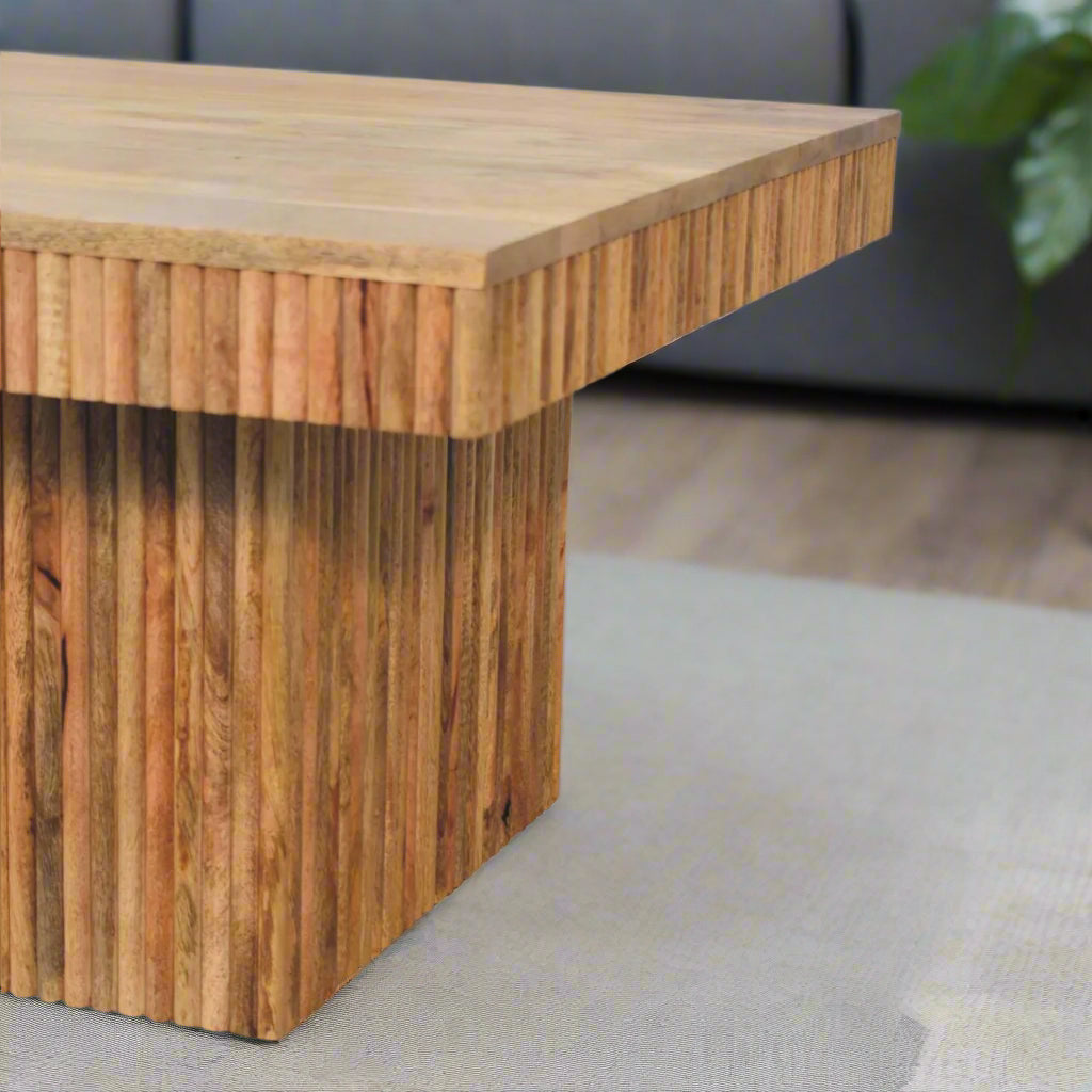 ngled view focusing on the thick ridged base and a section of the Soba Chunky Coffee Table, emphasizing its unique design feature.