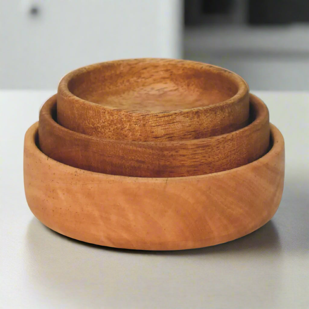 Front view of three stacked mango wood bowls showing uniform natural grain.