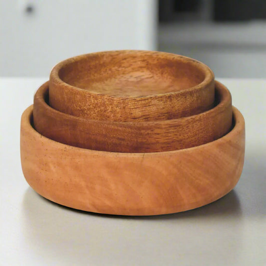 Front view of three stacked mango wood bowls showing uniform natural grain.