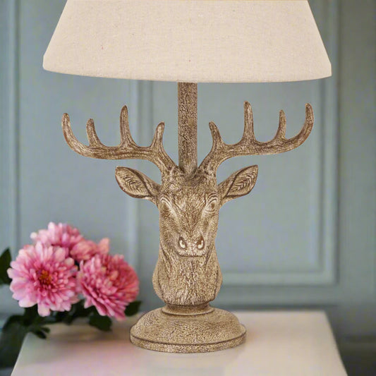 Close-up of stag head lamp base with aged patina and countryside-inspired design, sold by Purple Flamingo, a home décor store UK.