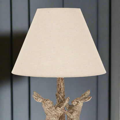 Close-up of the lamp’s linen shade, highlighting the fabric texture and soft natural tone.