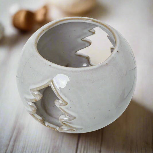 Birds eye view of white ceramic tea light holder displaying the inside and two cut out Fir tree shapes. Shop at Purple Flaimngo UK