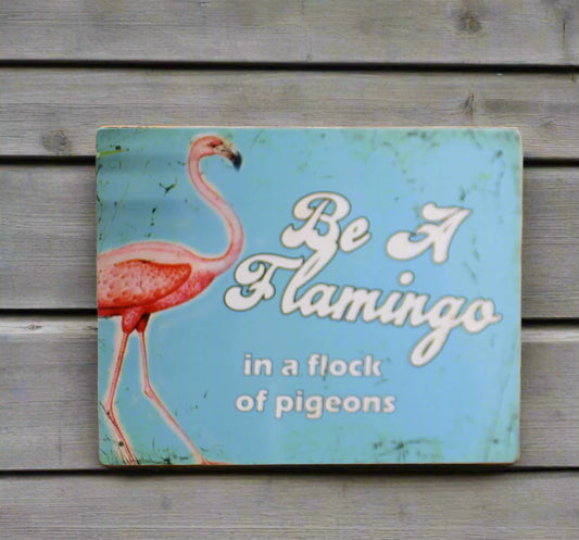 Vintage metal sign 'Be A Flamingo in a flock of pigeons', a retro art reproduction poster in light blue with a pink flamingo. Made in UK from aluminium, suitable for indoor or outdoor display. 