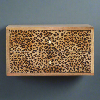 Front view of the wall mounted drawer table, prominently displaying its eye-catching leopard print drawer fronts and oak-ish finish.