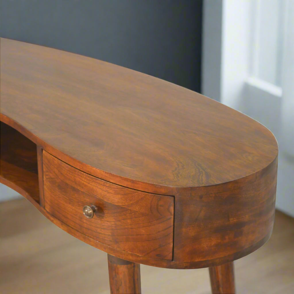 Elevated view of the left side of the Wave Desk, showing the top surface with its rich chestnut finish and the left mini drawer.