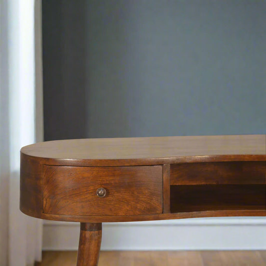 Front view of half of the Wave Desk, highlighting the right mini drawer with its shiny knob and the open storage slot.