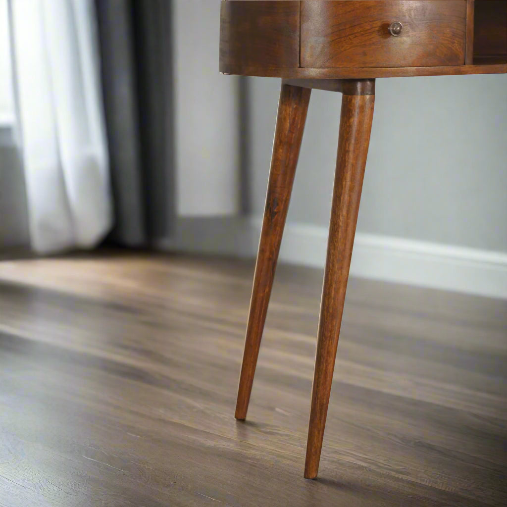 Front close-up view focusing on the elegantly tapered Nordic style legs of the Wave Desk, showcasing their solid mango wood construction.