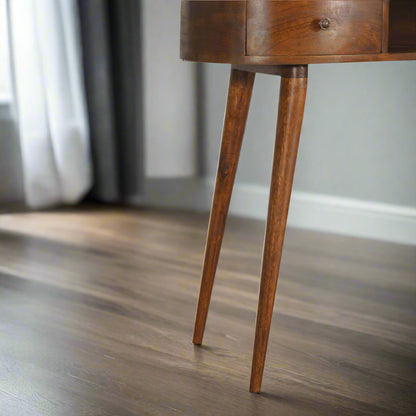 Front close-up view focusing on the elegantly tapered Nordic style legs of the Wave Desk, showcasing their solid mango wood construction.