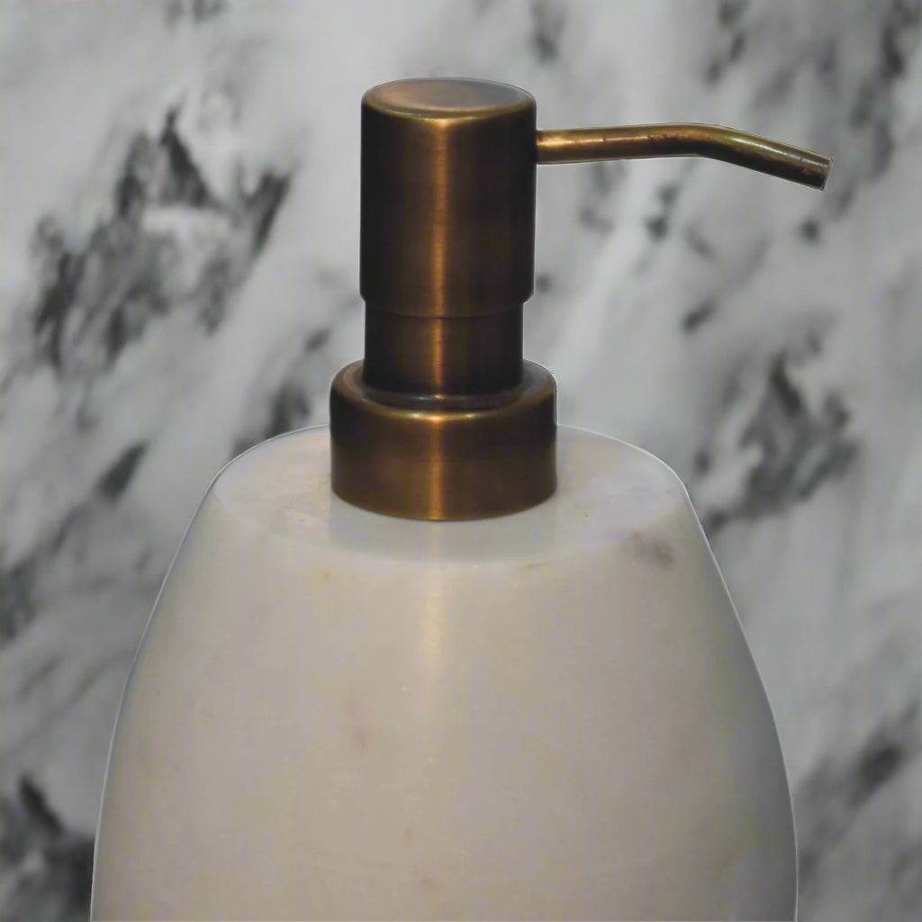 Close-up shot of the dispensing head of the white marble dispenser.
