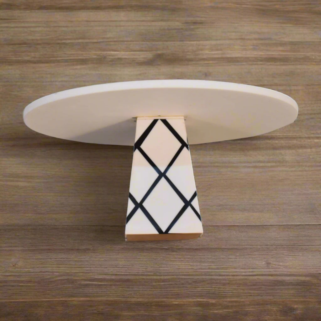 Close-up detail of the White Marble & Resin Cake Stand's elegant cross pattern design on the base.