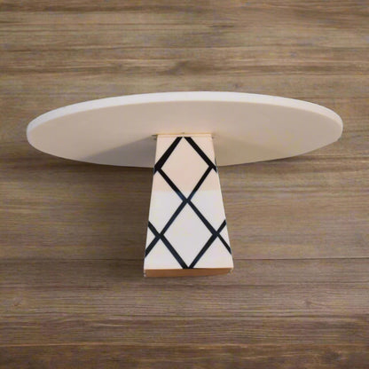 Close-up detail of the White Marble & Resin Cake Stand's elegant cross pattern design on the base.