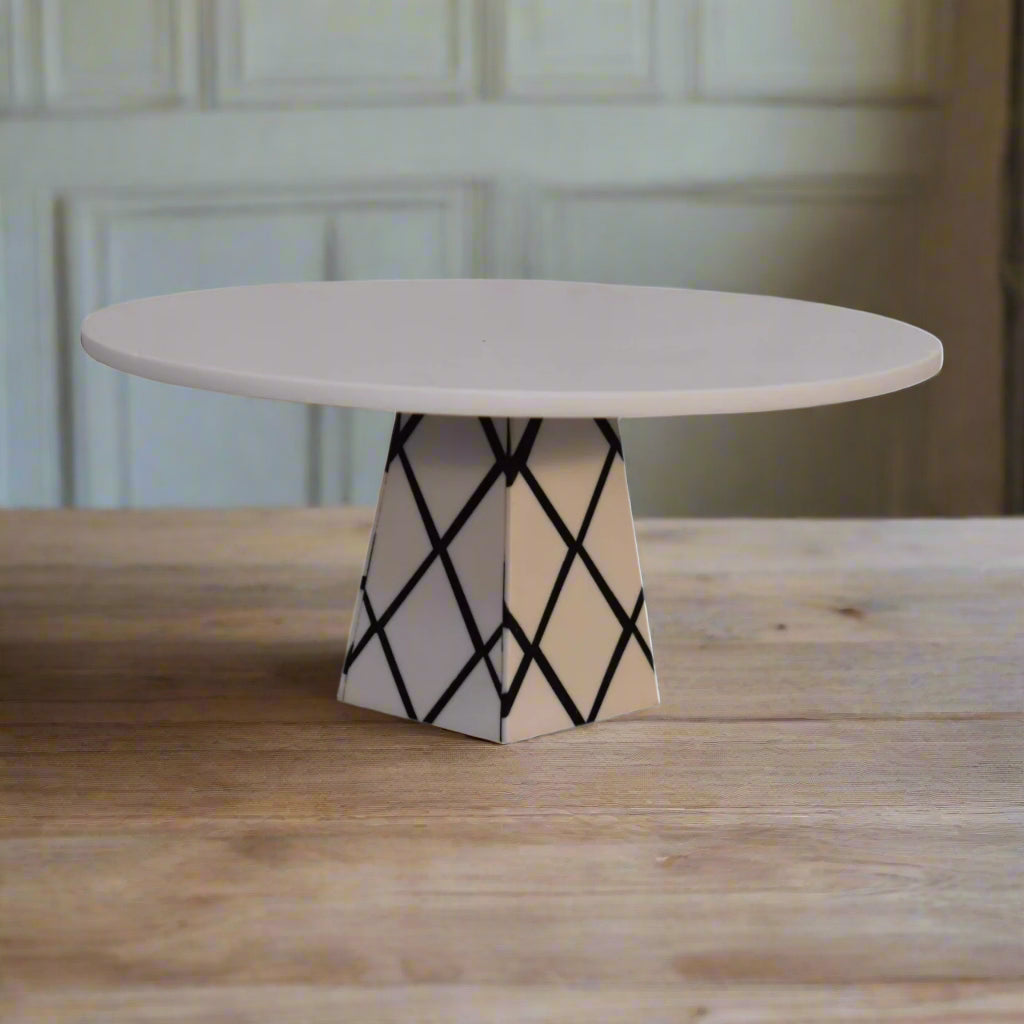 Angled view of the White Marble & Resin Cake Stand, highlighting its distinctive cross pattern design on the base.