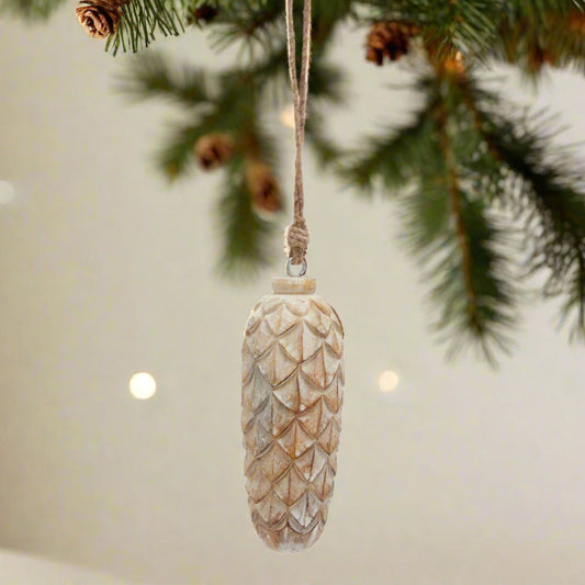 beautiful wintry large white wash pinecone hanging from a Christmas Tree