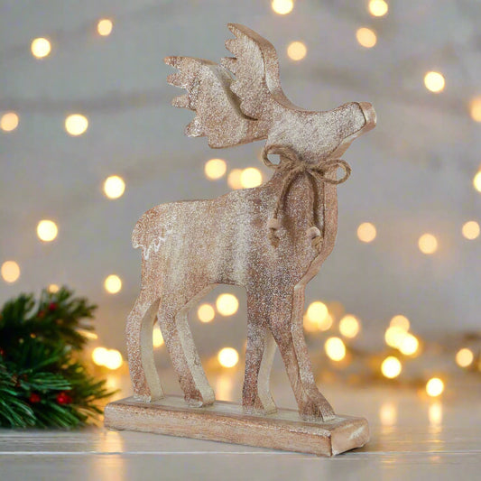Wooden stag ornament with glittery white wash finish on a cream festive setting