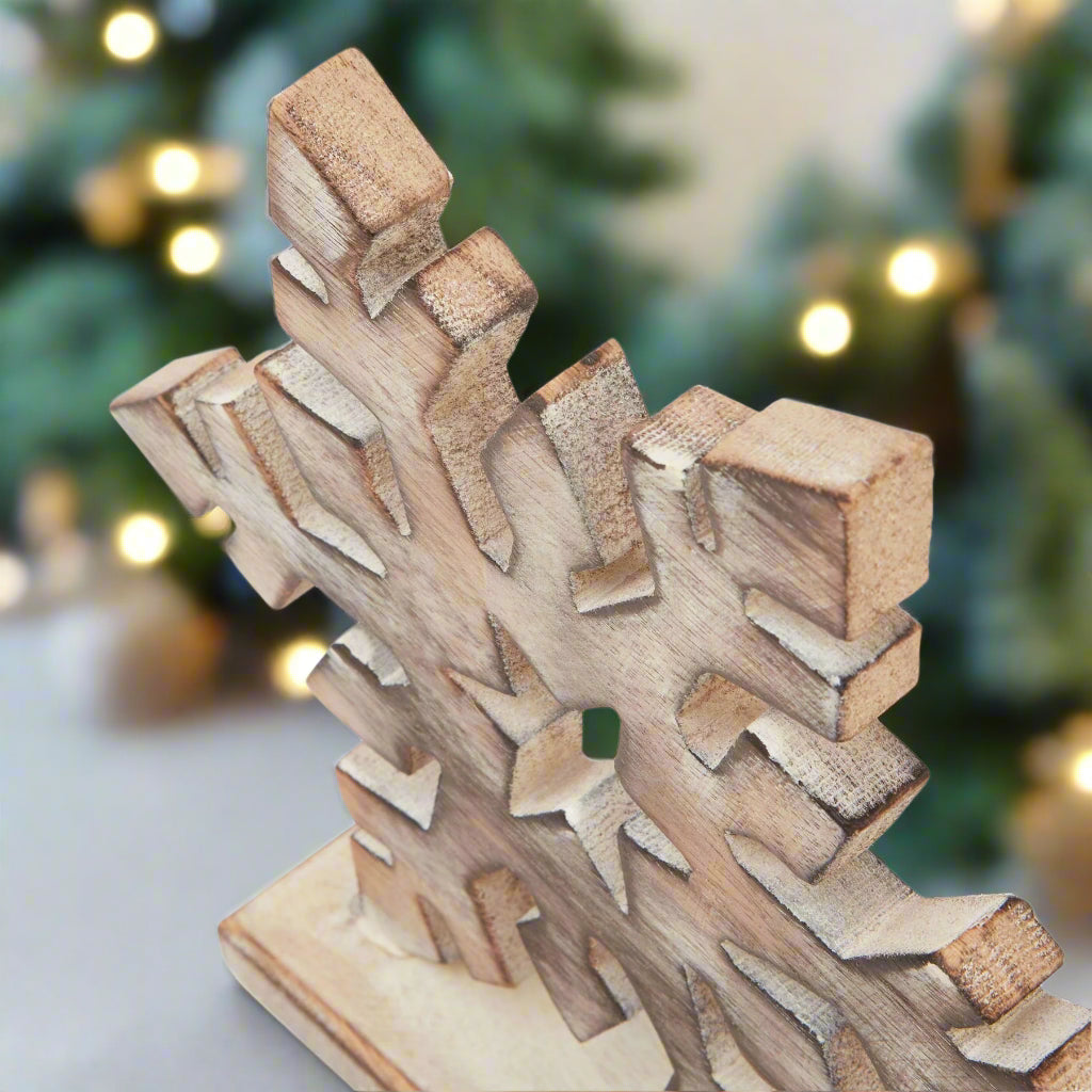 showcasing the intricate detailing of the wooden snowflake and white white finish in a festive setting