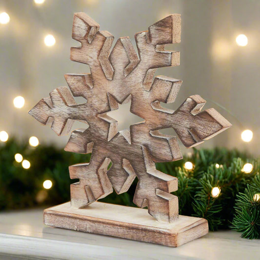 beautiful wooden snowflake ornament finished with a rustic white wash in a festive setting.