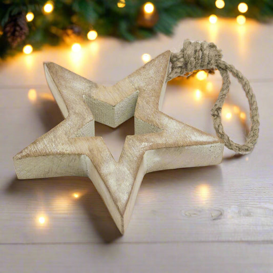 Angled view of a white wash small wooden hanging star decoration, highlighting its rustic charm and cut-out design.