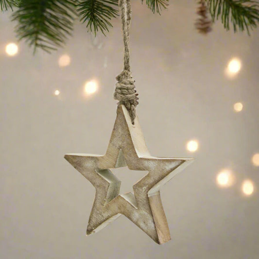 A rustic white wash small wooden hanging star decoration with a cut-out centre and rope hanger, perfect for Christmas trees or farmhouse-inspired home decor.
