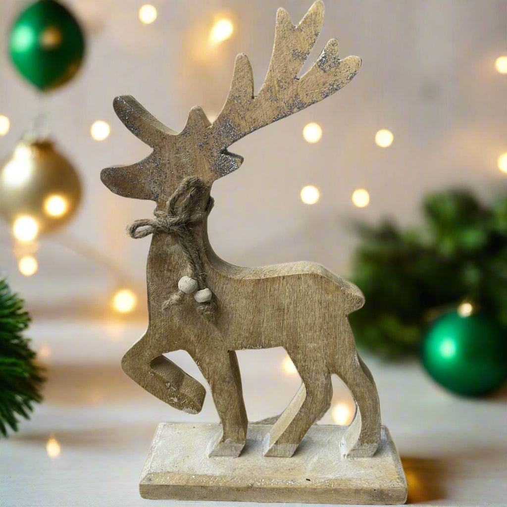 wooden reindeer with glittery antlers and twine neck tie placed in a festive setting