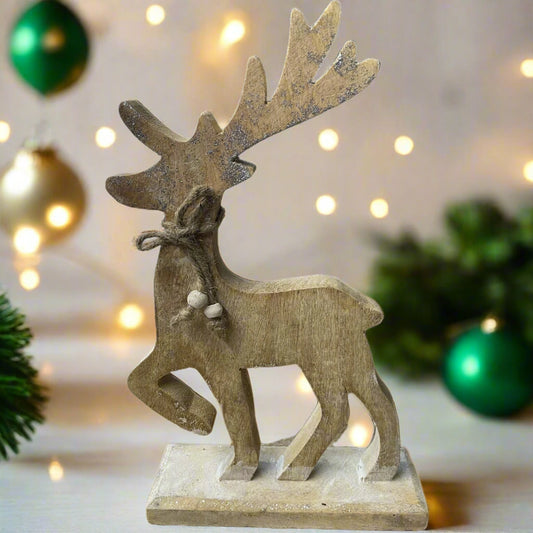 wooden reindeer with glittery antlers and twine neck tie placed in a festive setting