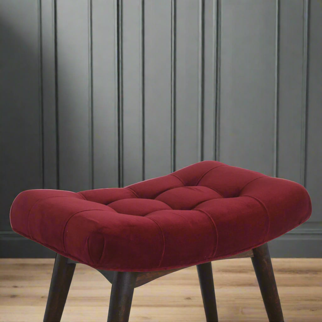 Elevated angled close-up of the Wine Red Velvet Curve Stool, focusing on the upholstered seat and upper section of the Nordic style legs.