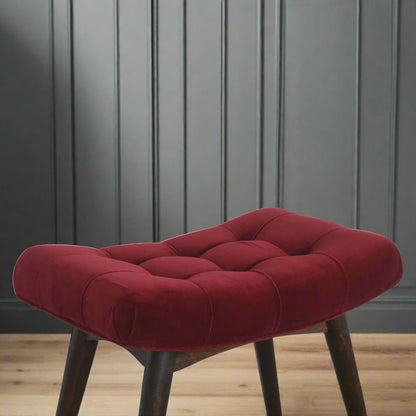 Elevated angled close-up of the Wine Red Velvet Curve Stool, focusing on the upholstered seat and upper section of the Nordic style legs.
