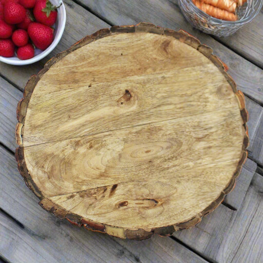 Top-down view of the round wooden bark design chopping board showing the natural wood grain and raw bark trim, ideal as a centrepiece or serving tray.